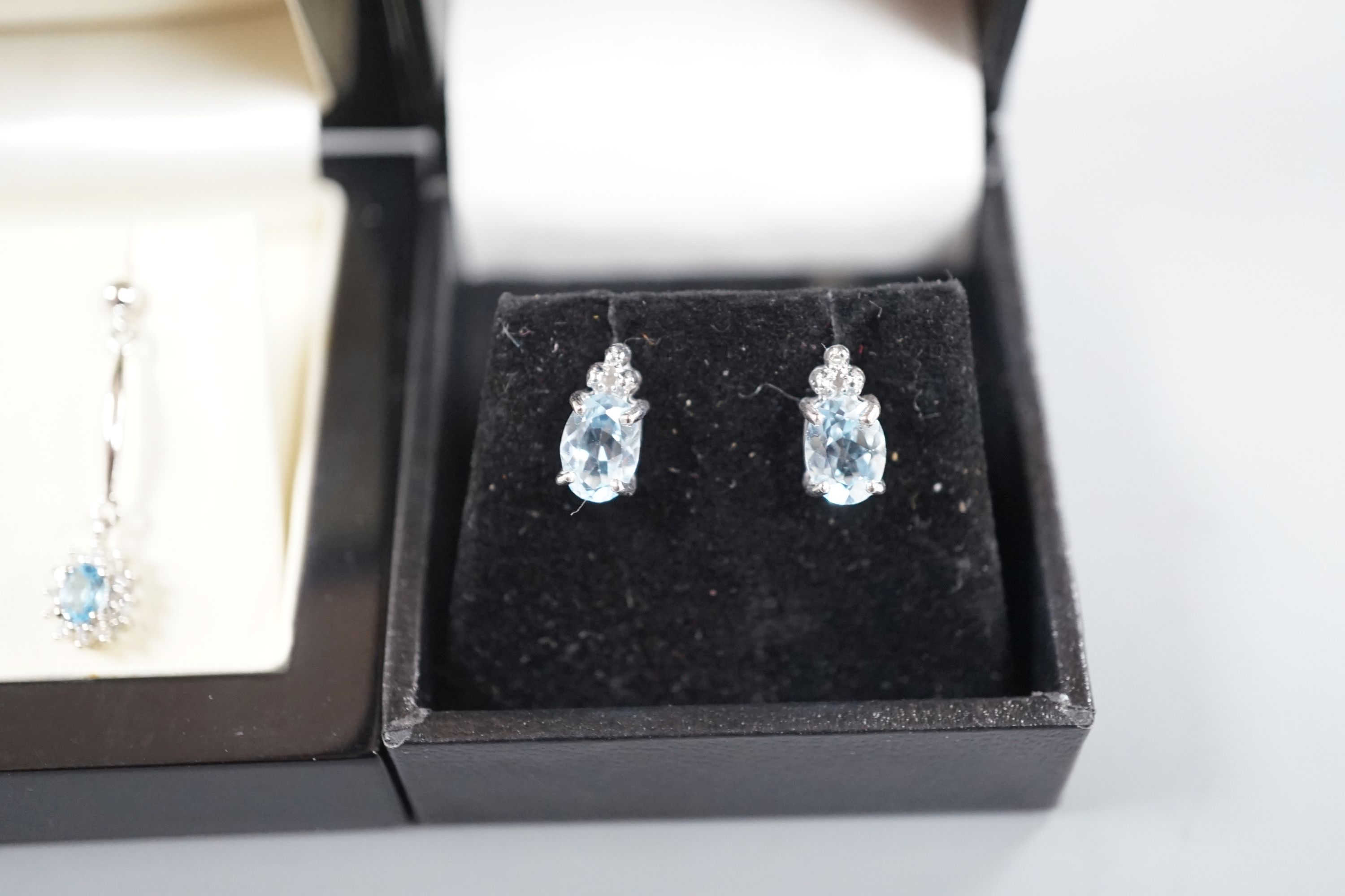 Three assorted modern pairs of gem set earrings, two white metal stamped 375 and one pair stamped 925.